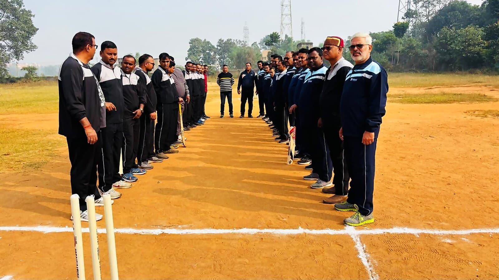 Young cricket teams lined up on a village ground for an inter-village match supported by Inland Power.