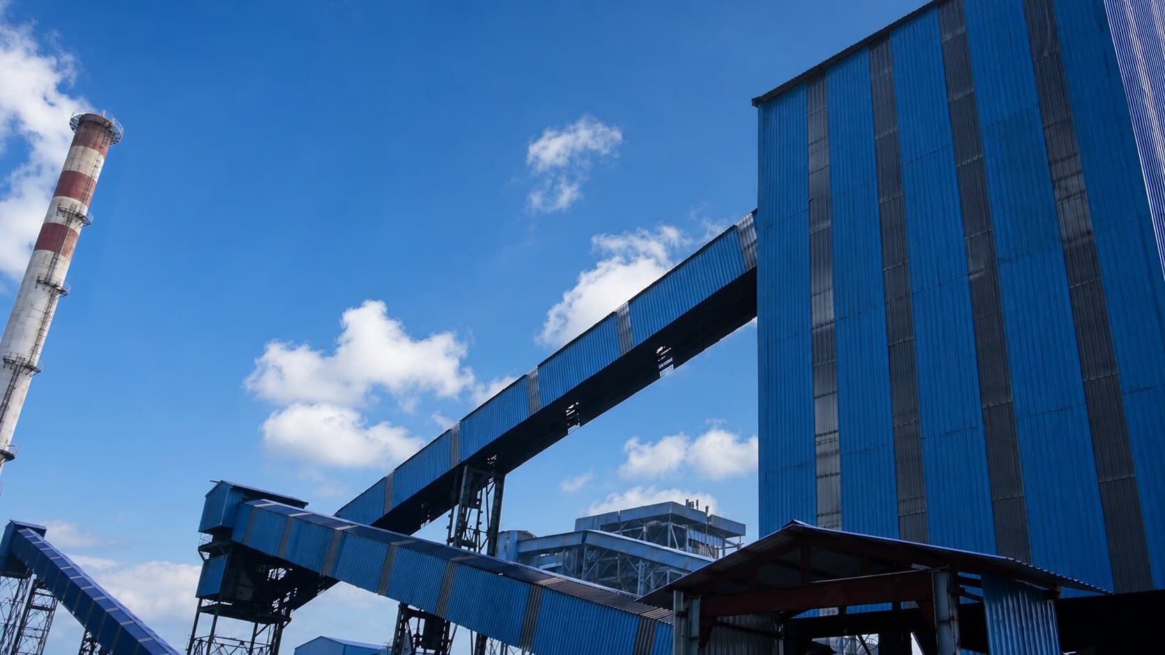 The 63 MW CFBC thermal power plant at Inland Nagar: banded chimney, conveyor gallery and boiler house.